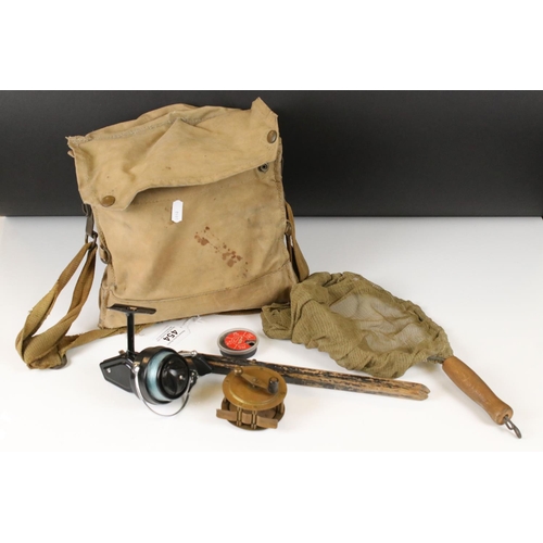 454 - A small collection of fishing tackle to include to reels contained within a tackle bag.