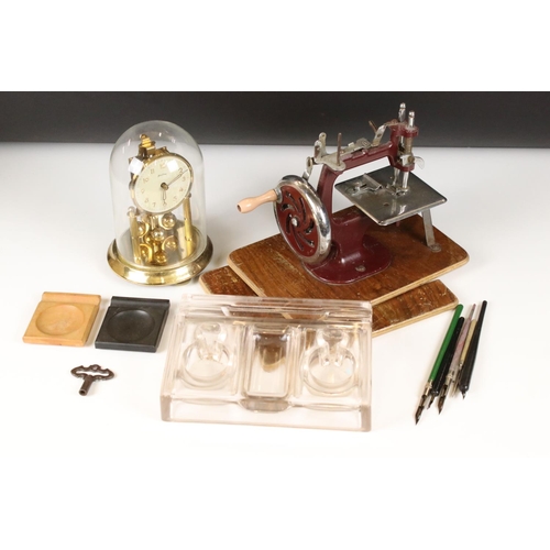 458 - A small box of mixed collectables to include a sewing machine, anniversary clock and a standish.