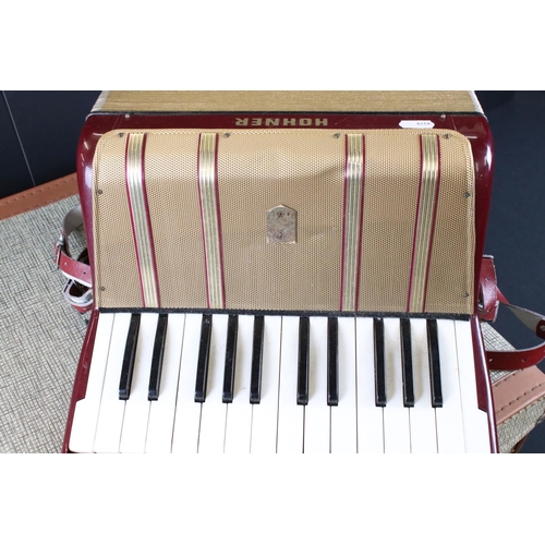 489 - Hohner ' Starlet 40 ' Red and Gold coloured Accordion, 31cm wide, in an un-related case