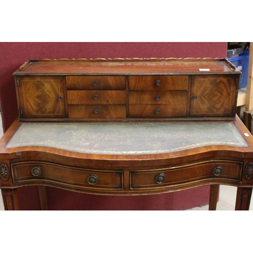 559 - 20th century Mahogany Serpentine Ladies Writing Desk, the superstructure with two cupboards and six ... 