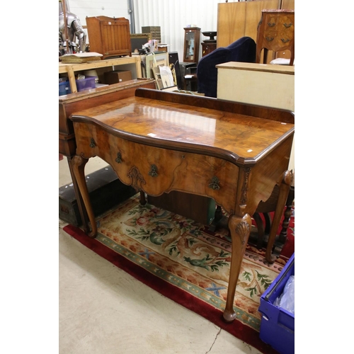 561 - Early 20th century Queen Anne style Walnut Side Table of serpentine outline, with two deep drawers, ... 