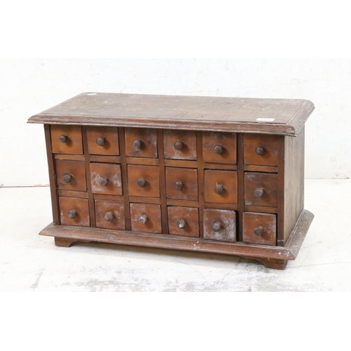 582 - Hardwood Table Top Multi-drawer Spice Cabinet of eighteen small drawers, 65cm wide x 35cm high