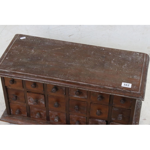 582 - Hardwood Table Top Multi-drawer Spice Cabinet of eighteen small drawers, 65cm wide x 35cm high