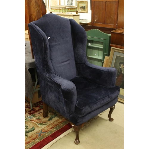 591 - High Wick Back Armchair in the Queen Anne style, upholstered in blue fabric, raised on front cabriol... 