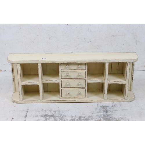 615 - Painted pine wall shelf of eight pigeonholes & four drawers, 89cm long x 32cm