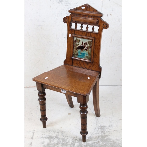 619 - Late 19th century Oak Hall Chair in the Aesthetic manner, with solid seat, the back inset with a Min... 