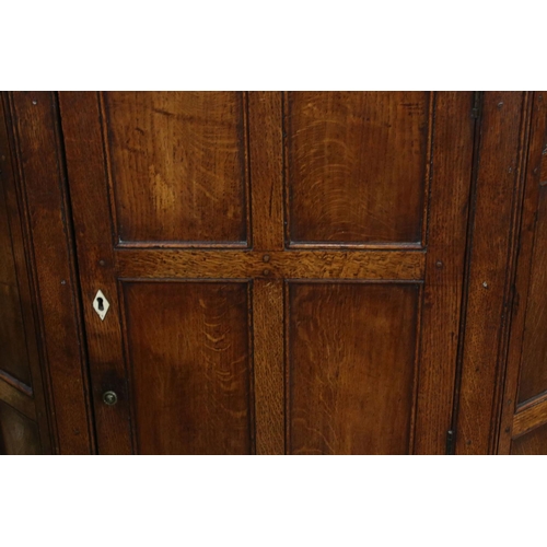 630 - George III Oak Hanging Corner Cupboard, the single panel door opening to three shelves, drawer below... 