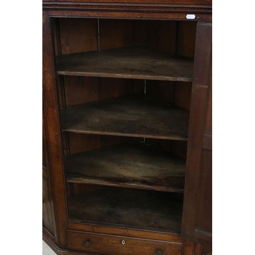 630 - George III Oak Hanging Corner Cupboard, the single panel door opening to three shelves, drawer below... 