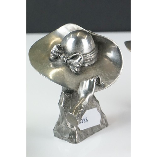 354 - A collection of four contemporary white metal hat ornaments, maker marked to verso.