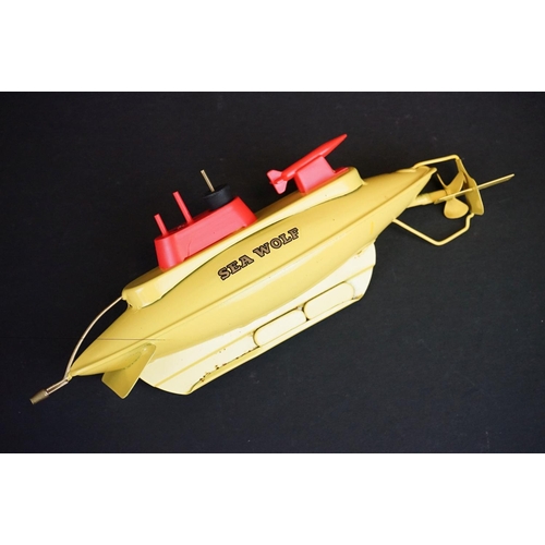 331 - Boxed Sutcliffe Model The Sea Wolf Atomic Submarine tinplate clockwork model in yellow, with key, a ... 