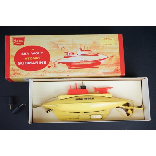 331 - Boxed Sutcliffe Model The Sea Wolf Atomic Submarine tinplate clockwork model in yellow, with key, a ... 