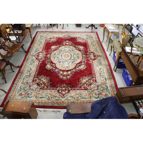 566 - Large Chinese Carpet, with floral pattern on a red and cream ground, 422cm x 307cm