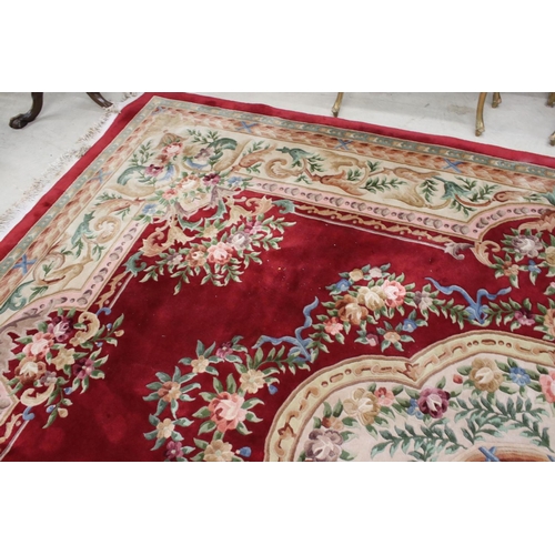 566 - Large Chinese Carpet, with floral pattern on a red and cream ground, 422cm x 307cm