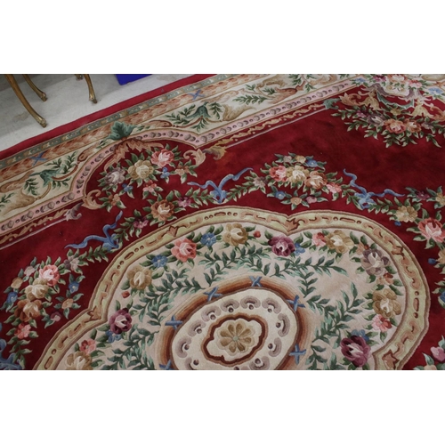 566 - Large Chinese Carpet, with floral pattern on a red and cream ground, 422cm x 307cm