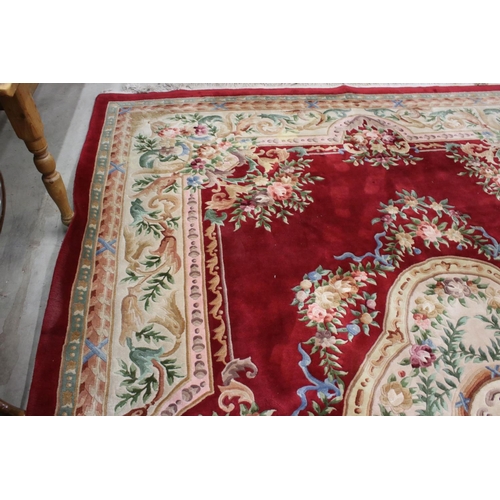 566 - Large Chinese Carpet, with floral pattern on a red and cream ground, 422cm x 307cm