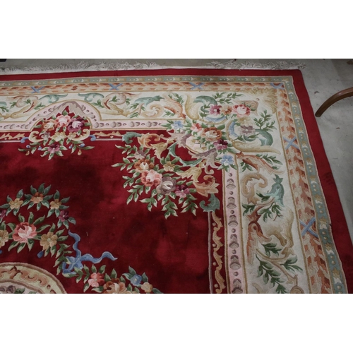 566 - Large Chinese Carpet, with floral pattern on a red and cream ground, 422cm x 307cm