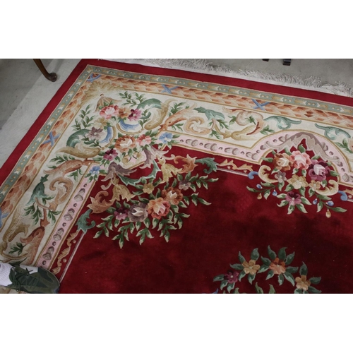 566 - Large Chinese Carpet, with floral pattern on a red and cream ground, 422cm x 307cm