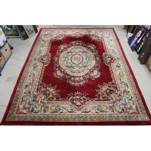 574 - Large Chinese Carpet, with floral pattern on a red and cream ground, 366cm x 277cm