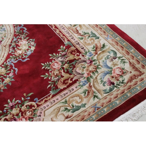 574 - Large Chinese Carpet, with floral pattern on a red and cream ground, 366cm x 277cm