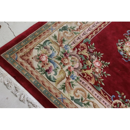 574 - Large Chinese Carpet, with floral pattern on a red and cream ground, 366cm x 277cm