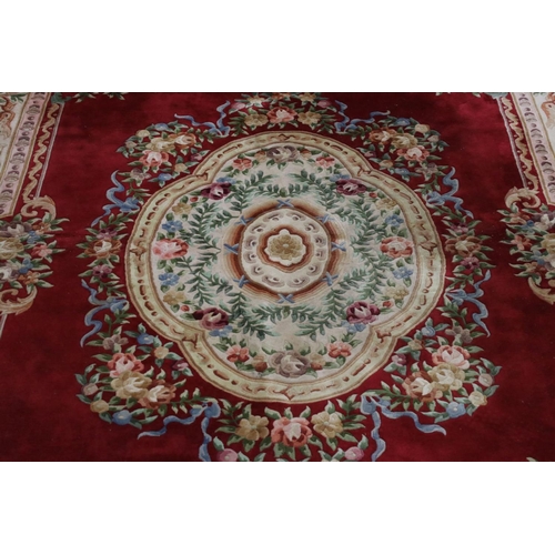 574 - Large Chinese Carpet, with floral pattern on a red and cream ground, 366cm x 277cm