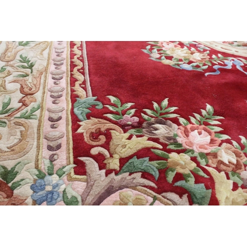 574 - Large Chinese Carpet, with floral pattern on a red and cream ground, 366cm x 277cm