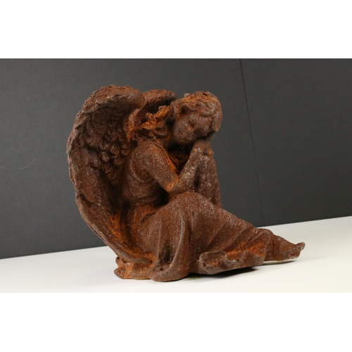 120 - Cast Iron Angel sat with her head resting on her knee, probably 19th century, 23cm high