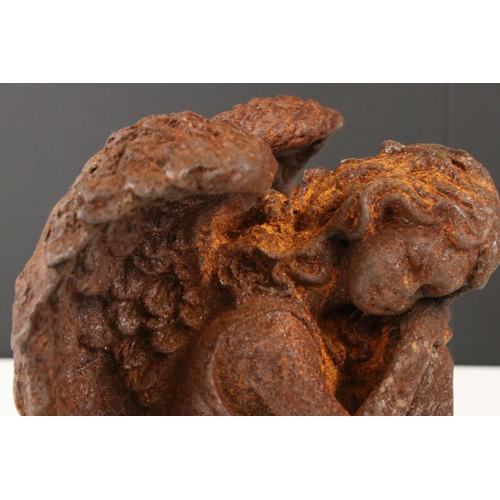 120 - Cast Iron Angel sat with her head resting on her knee, probably 19th century, 23cm high