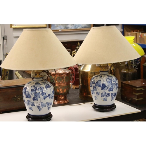 128 - Pair of Blue and White Ceramic Baluster Double Branch Table Lamps decorated with leaves, 66cm high, ... 