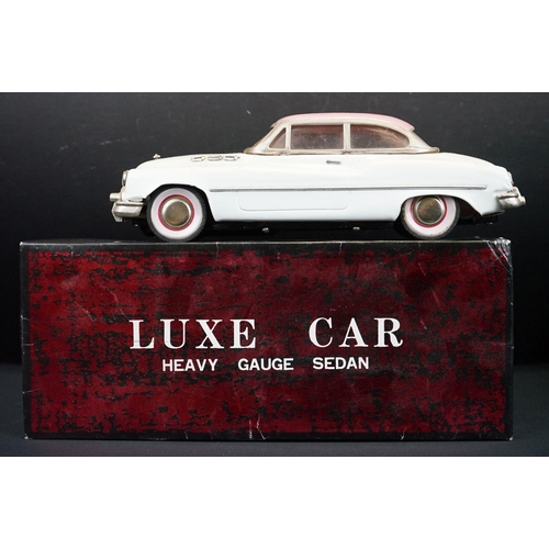 440 - Two boxed tinplate Luxe Car Heavy Gauge Sedan models, one cream with pink roof, the other blue