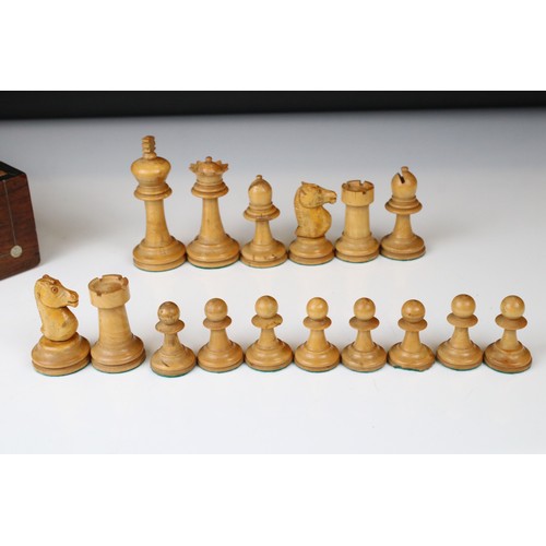 329 - A wooden chess set, in the style of Staunton, within a wooden box together with a wooden chess board... 