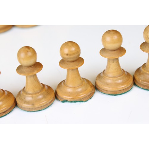 329 - A wooden chess set, in the style of Staunton, within a wooden box together with a wooden chess board... 