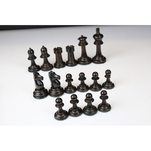 329 - A wooden chess set, in the style of Staunton, within a wooden box together with a wooden chess board... 