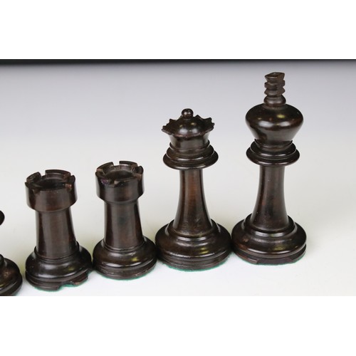 329 - A wooden chess set, in the style of Staunton, within a wooden box together with a wooden chess board... 