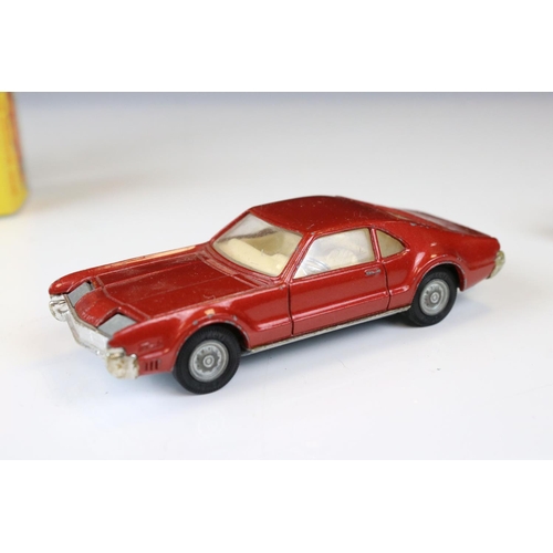 1386 - Boxed Corgi 341 Mini Marcos GT 850 diecast model in metallic red (a few spots of paint loss and box ... 