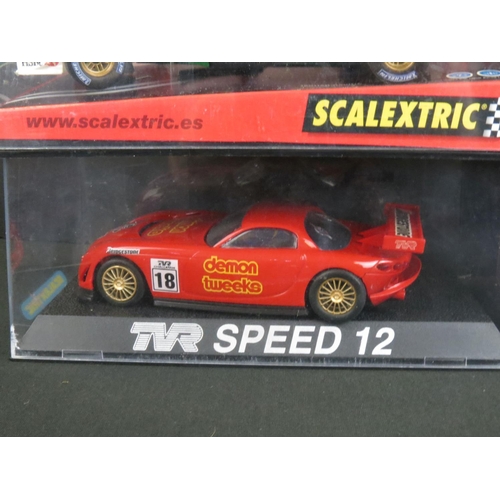 1306 - Five cased Scalextric slot cars to include Cadillac 2000 LMP, Audi R8, TVR Speed 12, Jaguar Racing F... 