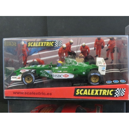 1306 - Five cased Scalextric slot cars to include Cadillac 2000 LMP, Audi R8, TVR Speed 12, Jaguar Racing F... 