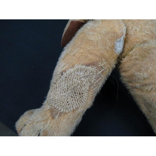 496 - Chad Valley jointed straw filled teddy bear with label to foot, red waistcoat, showing some wear and... 