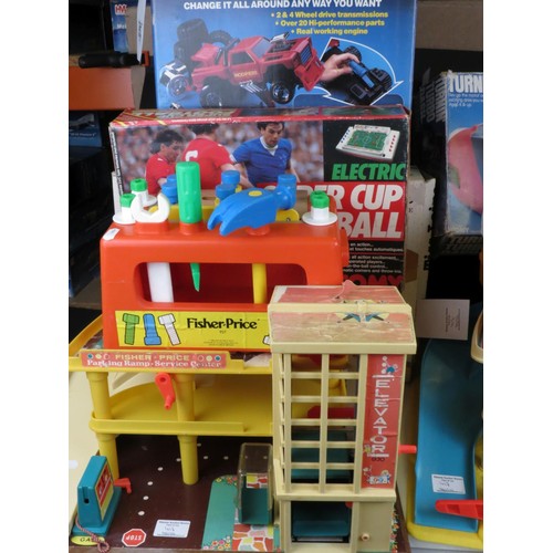 417 - Group of mixed vintage toys to include 2 x Fisher Price garages, boxed Tomy Super Cup Football, boxe... 