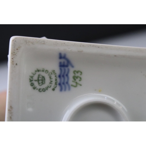 3 - Two Royal Copenhagen porcelain figures to include a faun playing a mouth organ seated on fluted colu... 