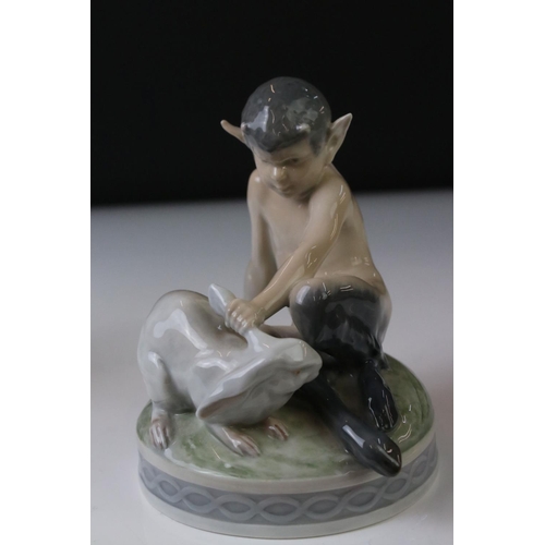 3 - Two Royal Copenhagen porcelain figures to include a faun playing a mouth organ seated on fluted colu... 