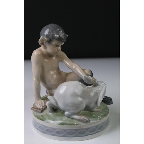 3 - Two Royal Copenhagen porcelain figures to include a faun playing a mouth organ seated on fluted colu... 
