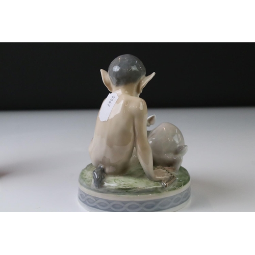 3 - Two Royal Copenhagen porcelain figures to include a faun playing a mouth organ seated on fluted colu... 