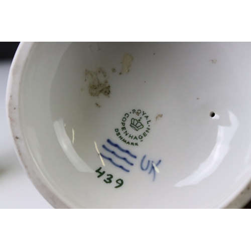 3 - Two Royal Copenhagen porcelain figures to include a faun playing a mouth organ seated on fluted colu... 