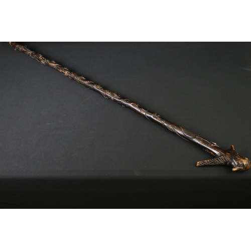 124 - 20th century tribal style carved wooden walking stick with figural two-faced handle; snake, animal m... 