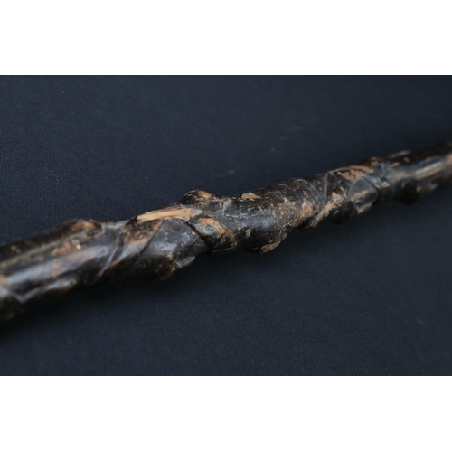 124 - 20th century tribal style carved wooden walking stick with figural two-faced handle; snake, animal m... 