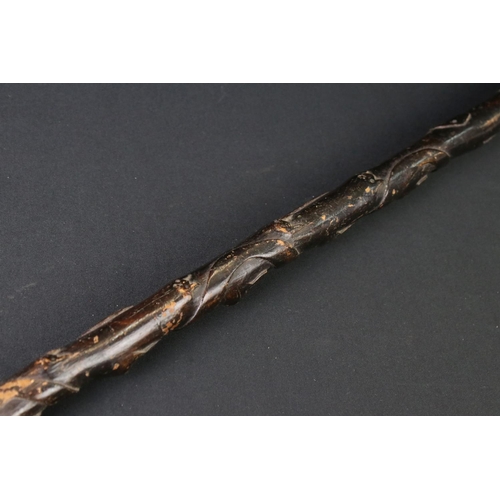 124 - 20th century tribal style carved wooden walking stick with figural two-faced handle; snake, animal m... 
