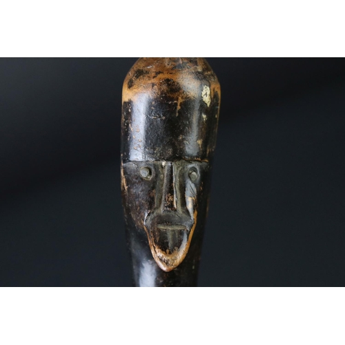 124 - 20th century tribal style carved wooden walking stick with figural two-faced handle; snake, animal m... 