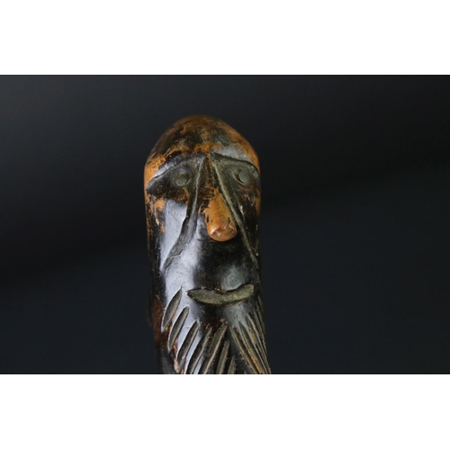 124 - 20th century tribal style carved wooden walking stick with figural two-faced handle; snake, animal m... 