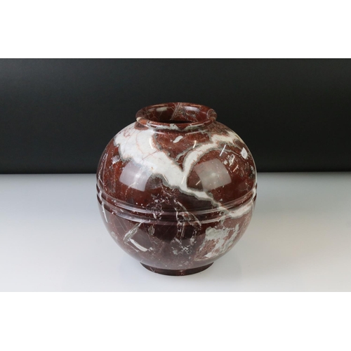 128 - Polished marble vase of spherical footed form, with tones of red and off-white, moulded rim and doub... 